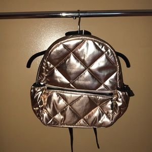 Rose gold quilted backpack
